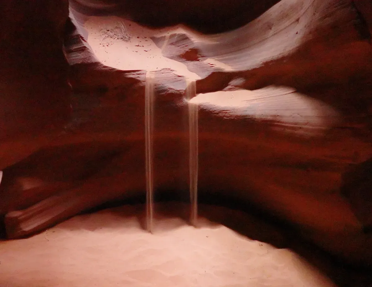 Sand falling inside Upper Antelope Canyon, a stop on an Antelope Canyon tour from Las Vegas, Page, Arizona.